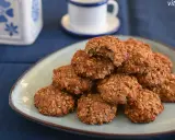 Montón de galletas proteicas caseras en un plato, con una taza de café al fondo. ¡Una deliciosa receta de cookies proteicas!