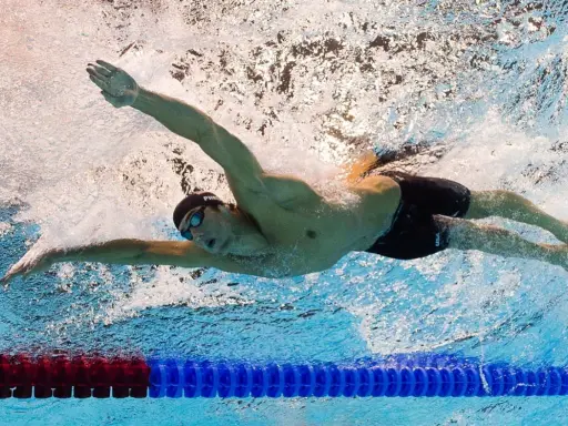 Nadador en estilo mariposa, demostrando que nadar es cardio y fuerza.