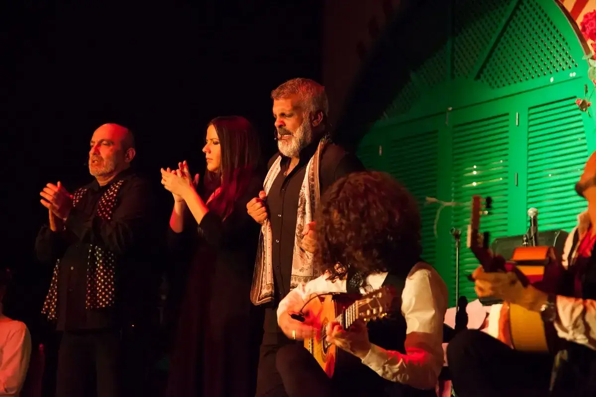 Cantantes de cante jondo, con palmas y guitarras, crean una atm&oacute;sfera flamenca.